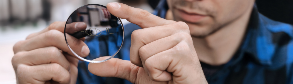 Man holding lenses illustrating key factors to consider when selecting the best optical lab management software, including workflow, integrations, and support.